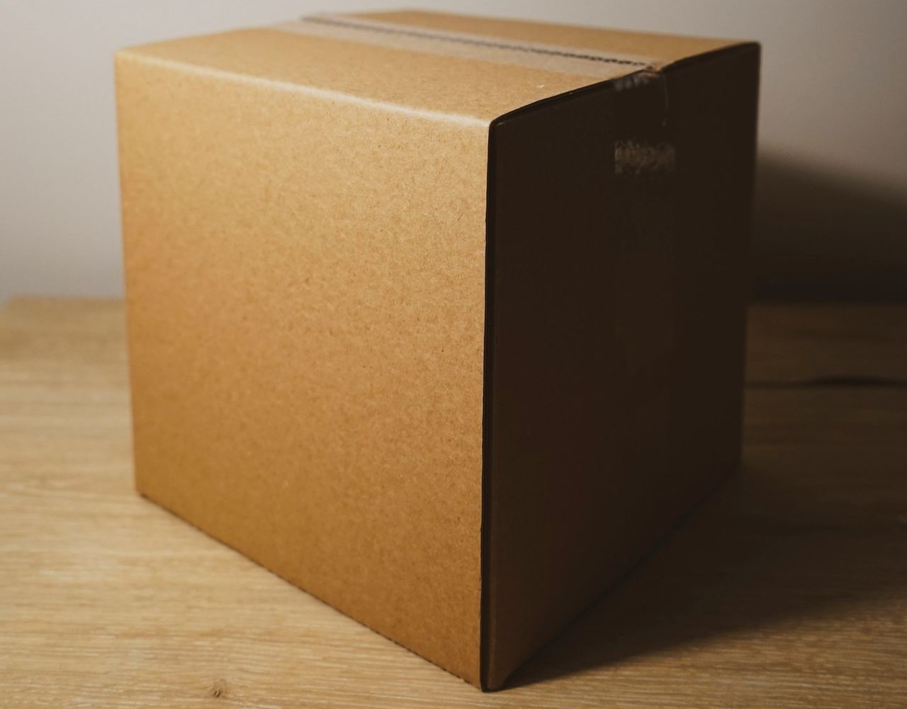 shallow focus photo of brown cardboard box